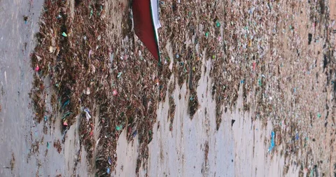 Sea waves full of litter hitting the beach. Huge dump in tropical paradise. M Video stock 127474918