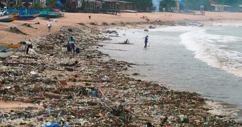 Sea waves full of litter hitting the beach. Huge dump in tropical paradise. M Stock Footage 127481292