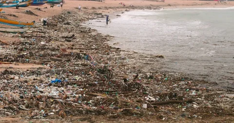 Sea waves full of litter hitting the beach. Huge dump in tropical paradise. M Stock Footage 127481415