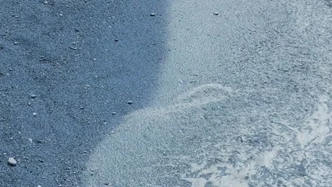 Sea waves gently rolling onto sandy shore Stock Footage 323433168