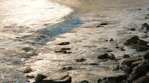 Sea Waves Gently Washing Rocks At Sunset. Slow motion Stock Footage 48773516