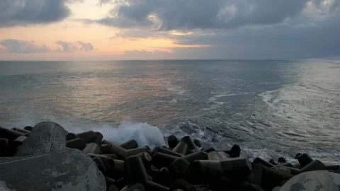 Sea waves hit concrete breakwaters 動画素材 291472007