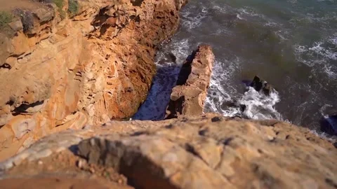 Sea waves hit a large rock with force, video taken from above Stock Footage 142399823