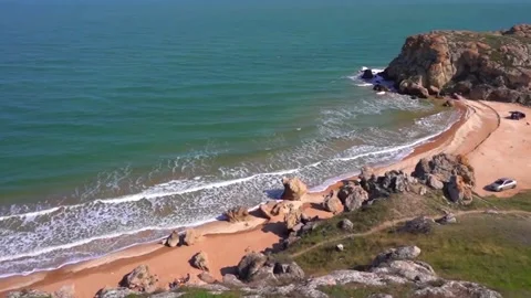 Sea waves hit a large rock with force, video taken from above Stock Footage 142399918