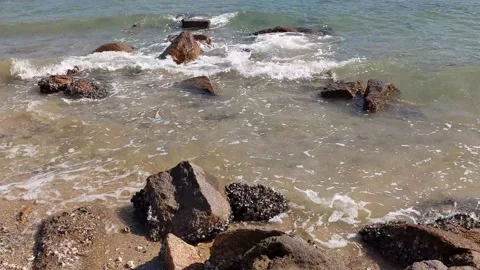Sea waves hit rocks on a beach Stock Footage 145927260