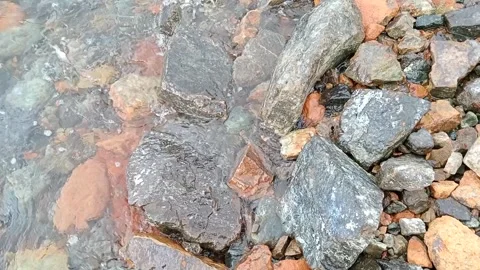Sea waves hit the rocks on the edge of the beach Stock Footage 277923706