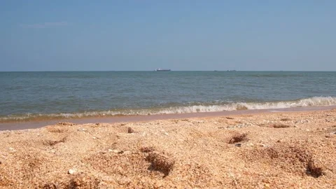 Sea waves hit the sandy shore. coast of sea. Wind and waves on a sunny day. Stock Footage 236922085