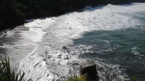 Sea waves hit the sea stack and create sea foam Stock Footage 294852051