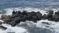 Sea waves hitting against big rocks and breaking into foam, water slow motion HD Footage