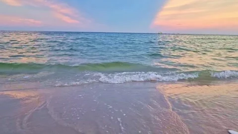 Sea waves hitting a golden sandy beach in the evening as the sun is about t.. Stock Footage 300077183