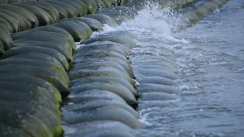 Sea waves hitting sand barriers Stock Footage 96493840