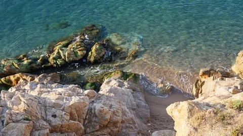 Sea waves hitting the white rock on a beach with sand, stones and pebbles 動画素材 102007948