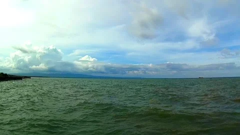Sea, waves, island, clouds Видео 337490696