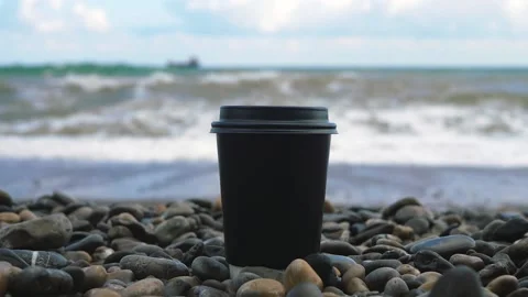 Sea waves knock down a cup Stock Footage 186123010
