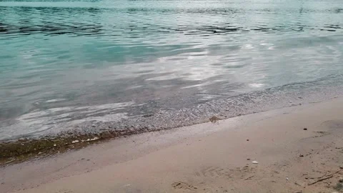 Sea waves lapping against shore. Sandy beach and blue water. Summer holiday Stock Footage 201274624