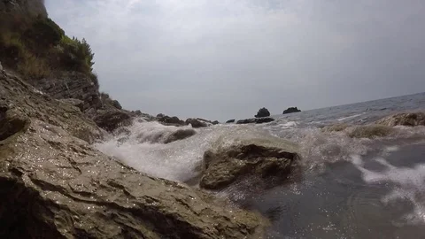 Sea waves lapping on the pebble beach. rocky shore and gentle sea wave video Stock Footage 82261096