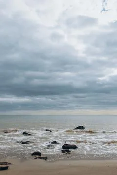 Sea waves lash line impact rock on the beach Stock Photos
