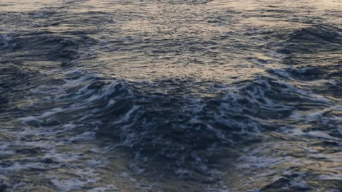 Sea waves left behind by a moving ship against the background of sunset Stock Footage 162541544