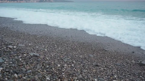 Sea waves on pebble beach texture background on sunset Stock Footage 237866529