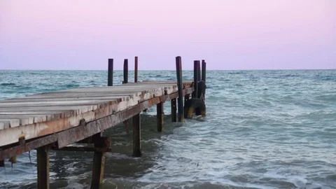Sea waves at the pier, sunset view Stock-Footage 70095972