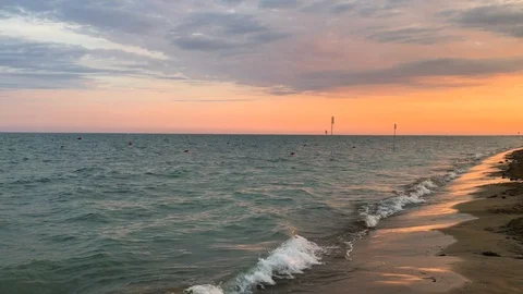 Sea waves on pink sunset, cloudy sky, aquamarine Stock Footage 93278383