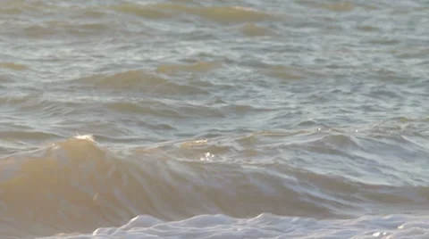 Sea waves reaching beach and turning into white foam Stock Footage 8365779