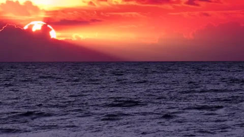 Sea waves on the red sunset background. Beautiful sunrays on the sky. Stock Footage 240240070