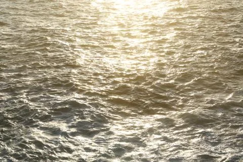 In the sea waves reflect the sun rays. Stock Photos