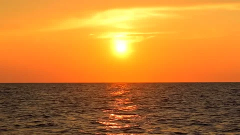 Sea waves with reflection of gold sunlight on the sky orange. ProRes 422 HQ. Stock Footage 247921624