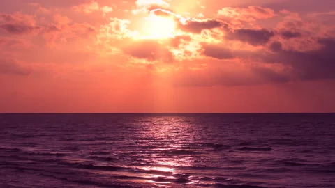 Sea waves with reflection of red sunlight on the red sunset background. Stock Footage 240491458