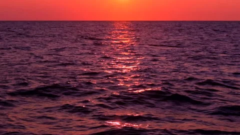 Sea waves with reflection of red sunset light . Stock Footage 239050735