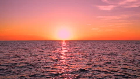 Sea waves with reflection of red sunset light on colorful sky. ProRes 422 HQ. Stock Footage 248850486