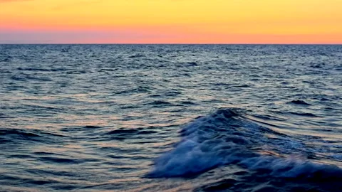 Sea waves with reflection of yellow sunset light. Stock Footage 239014048