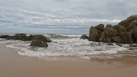 Sea waves rocky sandy beach cloudy day Stock-Footage 243086355