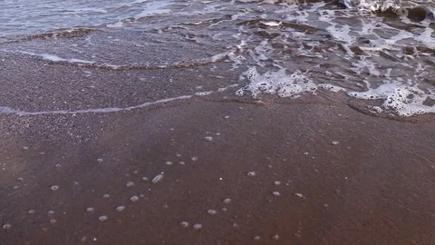 Sea ??waves roll ashore at sunset Stock Footage 125666875
