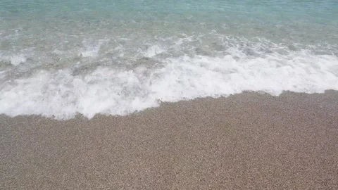 Sea waves roll onto sandy beach Stock Footage 316812757