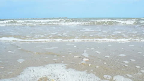 Sea waves rolling to the  beach. Close-Up of Waves and Sand on The Beach. Stock Footage 138041994