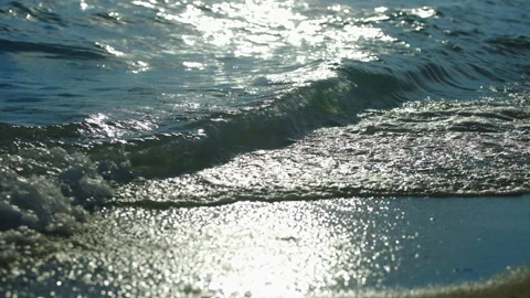 Sea waves rolling on beach Stockbeeldmateriaal 212699051