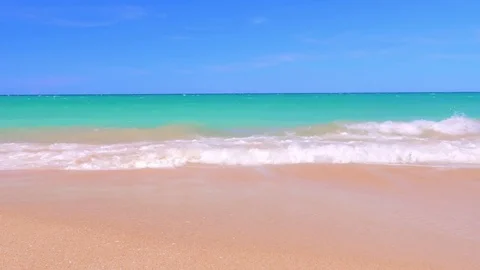 Sea waves rolling on clean sand beach of tropical ocean coast slow motion view Stock Footage
