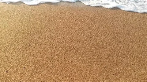 Sea waves rolling over the fine sand beach Stock Footage 138555436