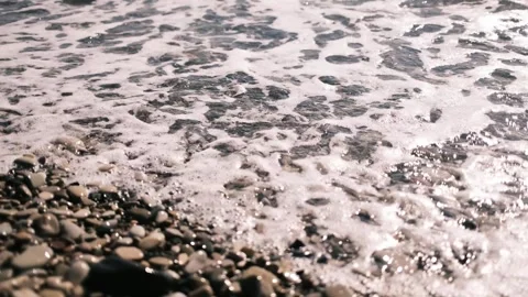 Sea waves rolling over a pebble beach on the Black Sea coast. Close top view of Stock Footage 325738293