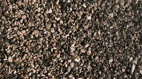 Sea waves rolling over a pebble beach on the Black Sea coast. Close top view of Stock Footage 325738888