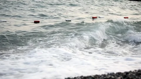 Sea waves rolling on the pebble beach shore. The concept of bad weather Stock Footage 162223715