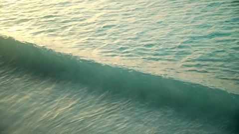 Sea waves rolling on sandy beach at sunset Stock Footage 105457845