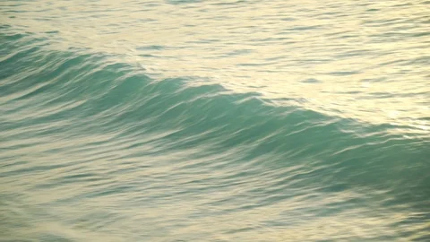 Sea waves rolling on sandy beach at sunset Stock Footage 105457895