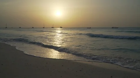 Sea Waves Rolling On Sandy Beach At Sunset 動画素材 107427133