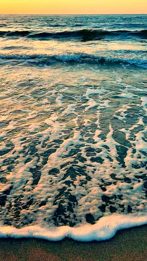Sea waves rolling sandy beach seashore in summer during sunset sunrise Vertical Stock Footage 284339766