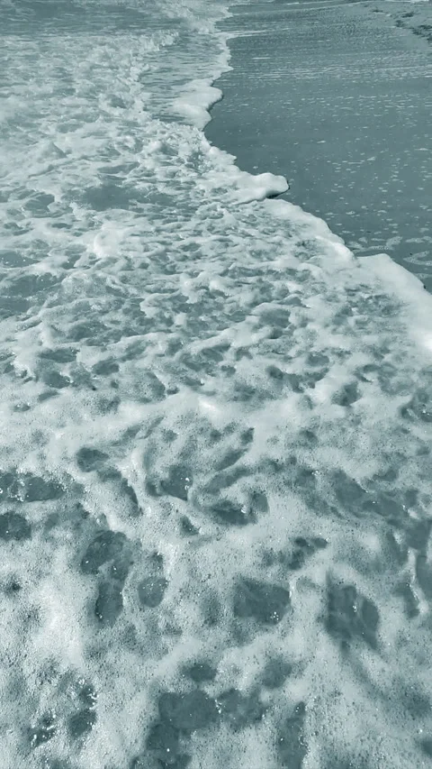 Sea waves rolling sandy beach on the seashore on summer sunny day Vertical Stock Footage 287714136