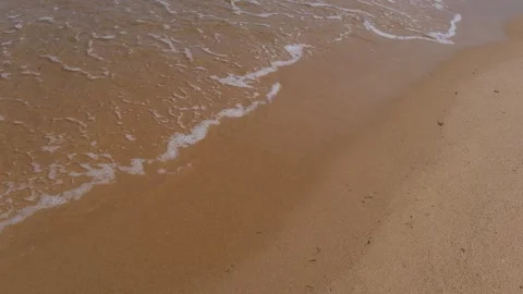 Sea waves rolling onto a sandy beach Vídeo Stock 336313274