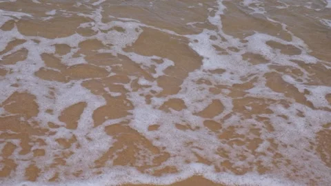 Sea waves rolling onto a sandy beach Vídeos de archivo 338083703